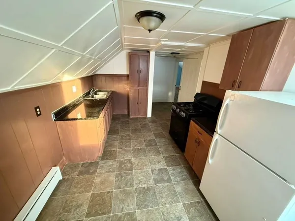 a view of a storage & utility room with two washing machine