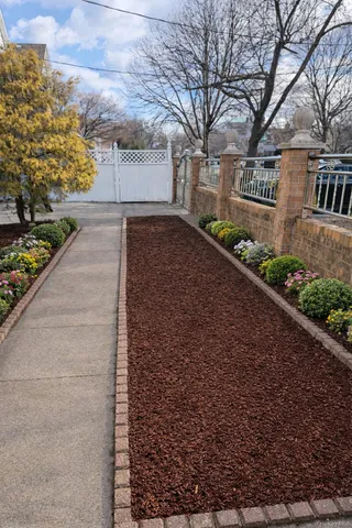 a front view of a house with a yard and trees