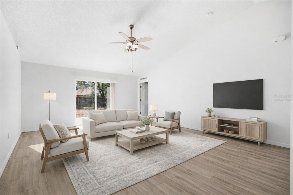 80 Providence Lane Palm Coast, FL 32164 - Photo 12 of 42 a living room with furniture and a flat screen tv