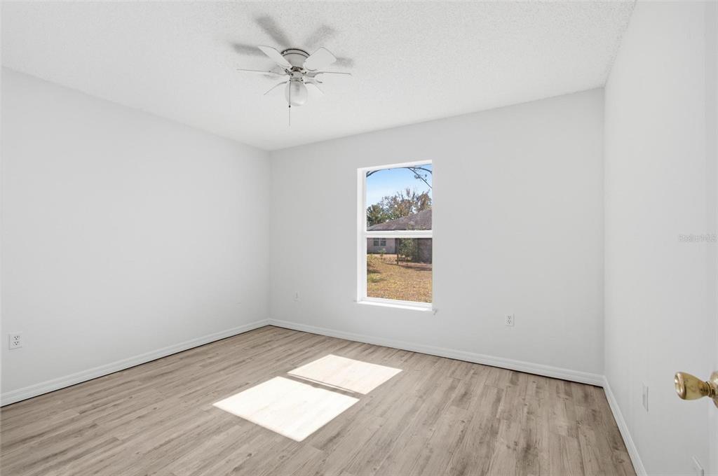 80 Providence Lane Palm Coast, FL 32164 - Photo 21 of 42 an empty room with a window and a ceiling fan