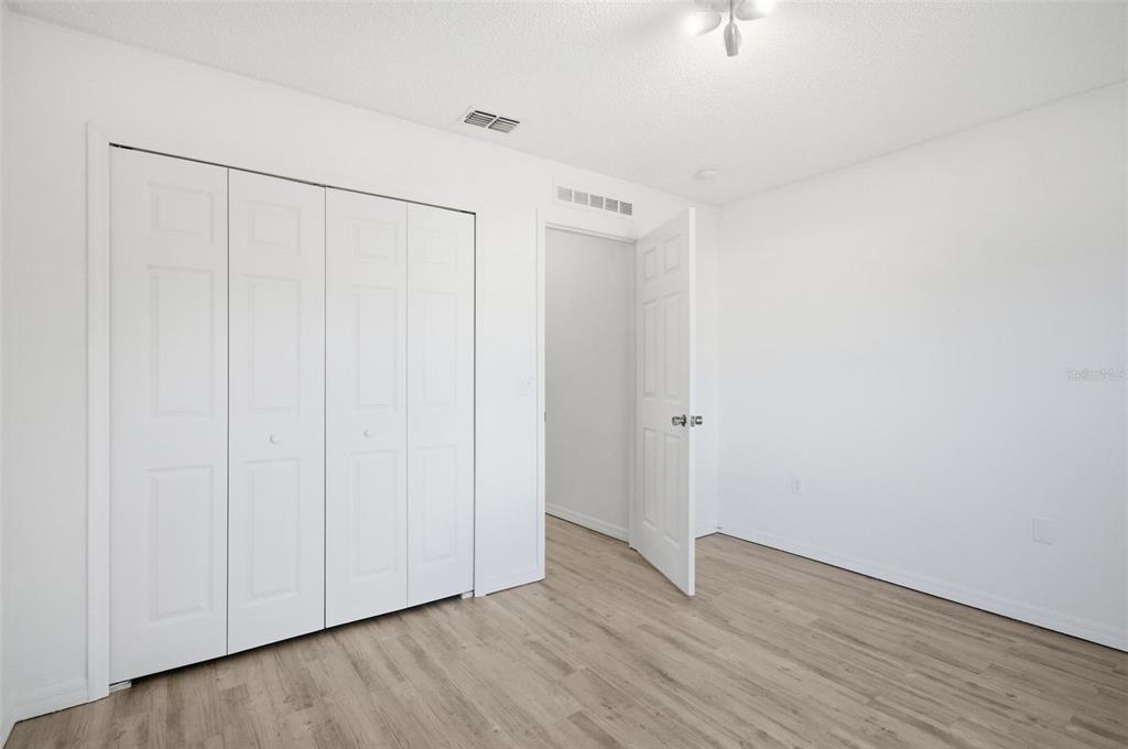 80 Providence Lane Palm Coast, FL 32164 - Photo 24 of 42 a view of an empty room with wooden floor