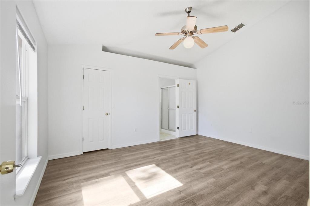 80 Providence Lane Palm Coast, FL 32164 - Photo 26 of 42 a view of a room with a ceiling fan and a window