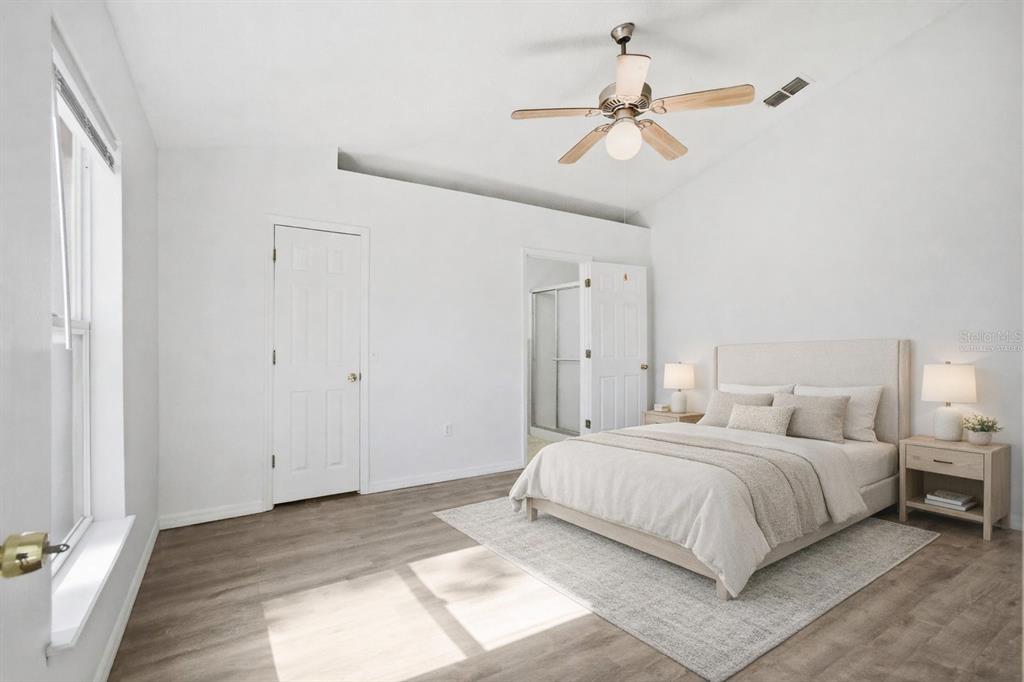 80 Providence Lane Palm Coast, FL 32164 - Photo 28 of 42 a bedroom with a bed and ceiling fan