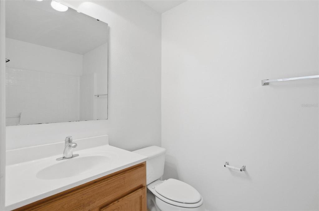 80 Providence Lane Palm Coast, FL 32164 - Photo 31 of 42 a bathroom with a sink a toilet and vanity