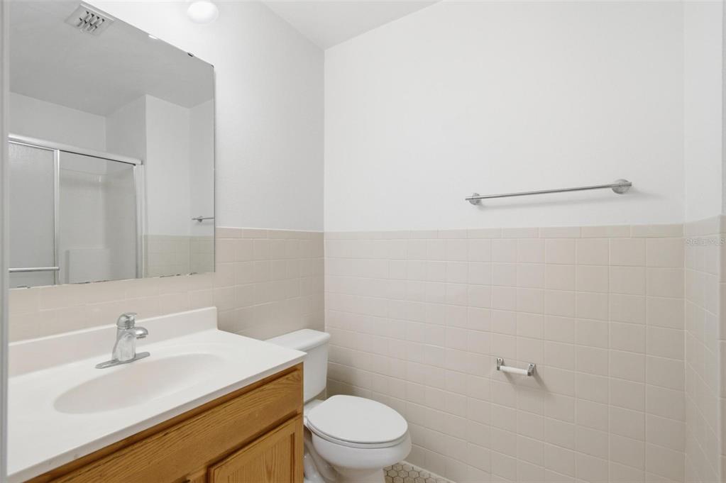 80 Providence Lane Palm Coast, FL 32164 - Photo 32 of 42 a bathroom with a sink a toilet and a mirror