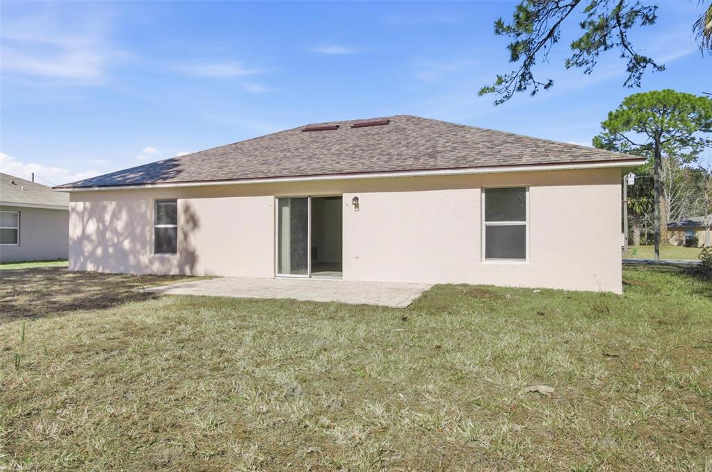 80 Providence Lane Palm Coast, FL 32164 - Photo 33 of 42 a house with trees in front of it