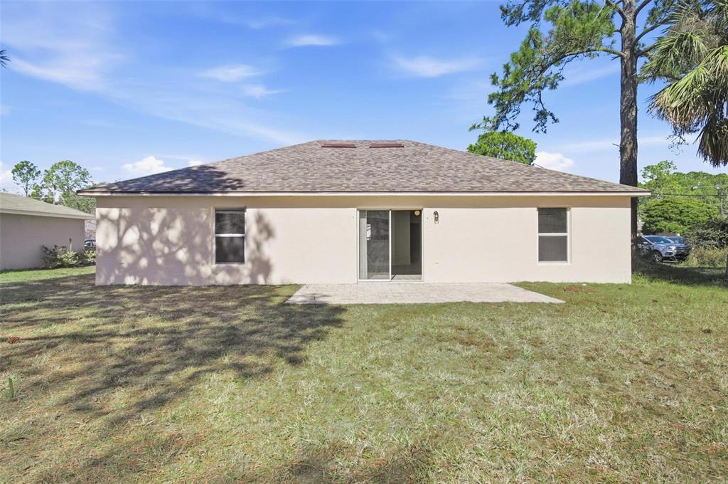 80 Providence Lane Palm Coast, FL 32164 - Photo 35 of 42 a front view of a house with a garden