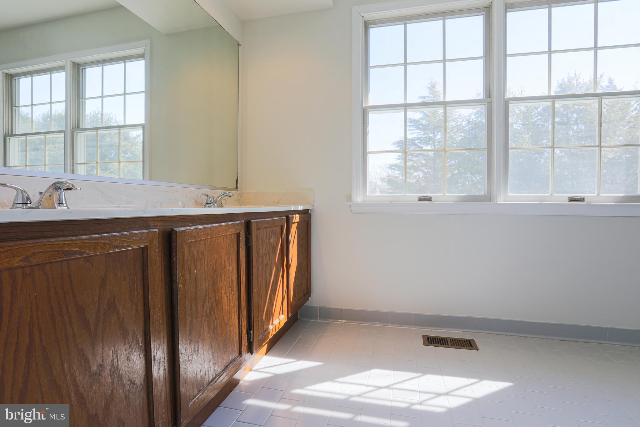 9547 Hallhurst Road Baltimore, MD 21236 - Photo 29 of 49 a view of cabinets with wooden floor and windows
