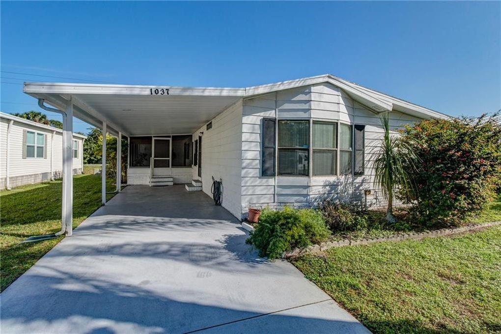 1037 Sebastian Road Barefoot Bay, FL 32976 - Photo 1 of 28 a front view of a house with a yard
