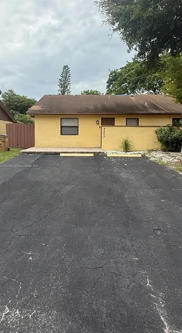 a view of a big yard with a table and a chair
