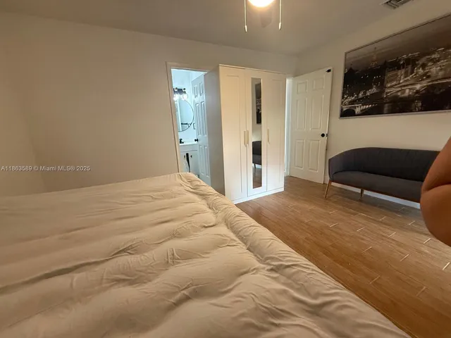 a bedroom with a bed a couch and closet