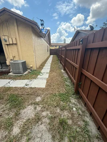 a view of a backyard with pathway