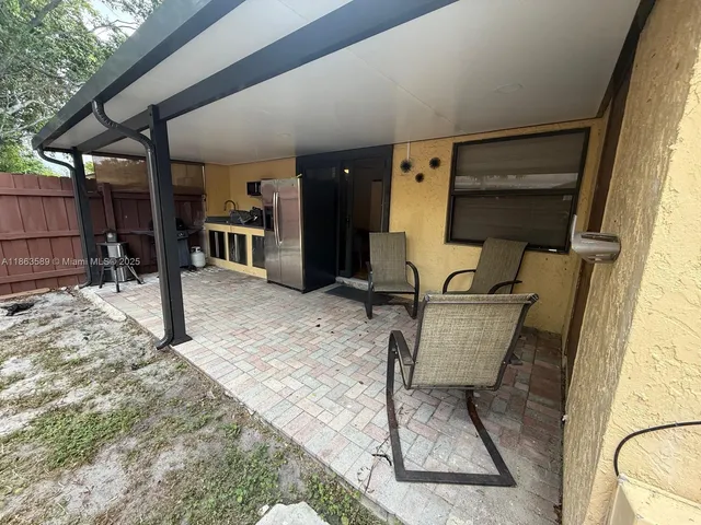 a view of a patio with a table and chairs