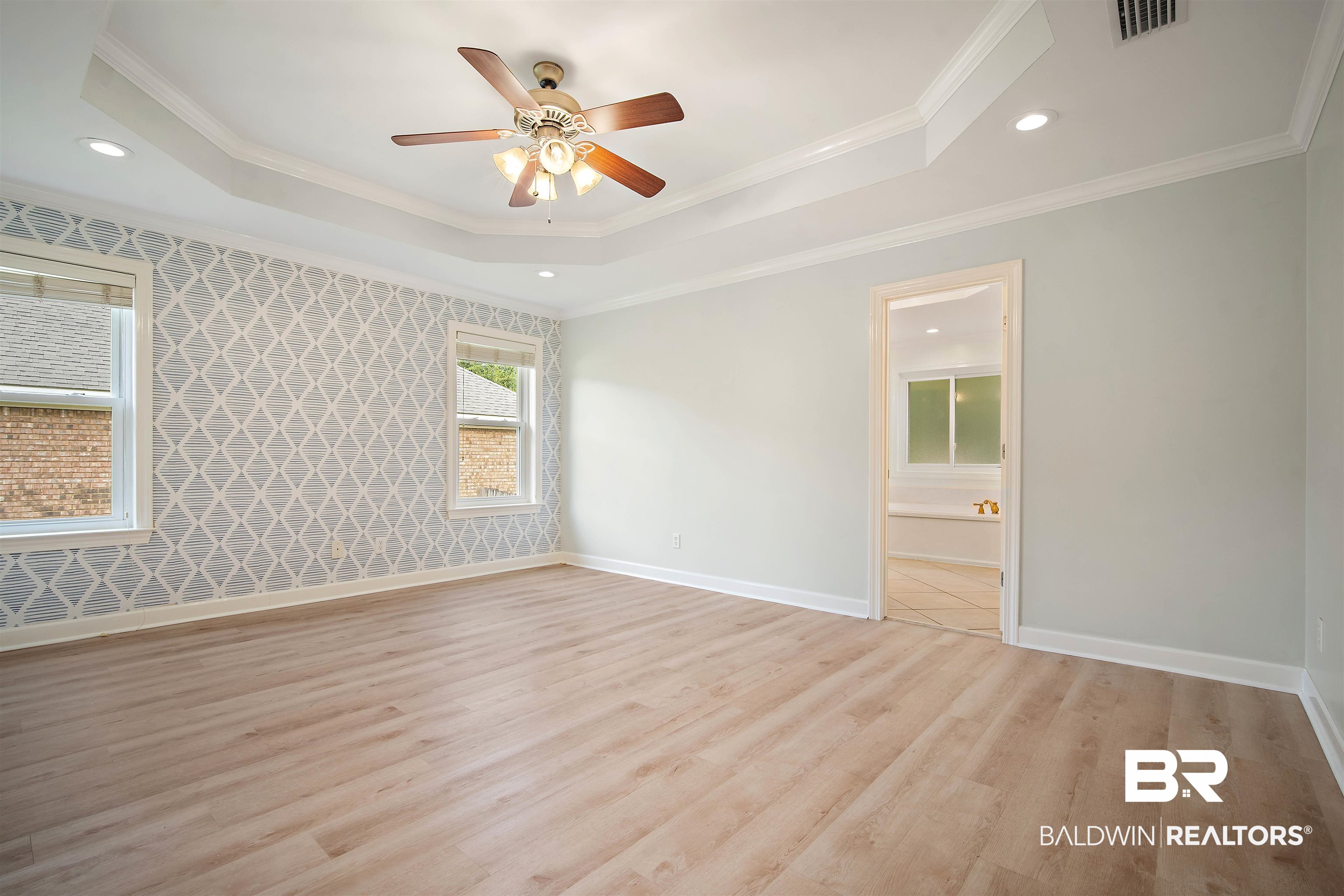 1685 Stonebridge Court Mobile, AL 36695 - Photo 13 of 29 Spare room featuring a tray ceiling, recessed lighting, light wood-type flooring, ornamental molding, and ceiling fan
