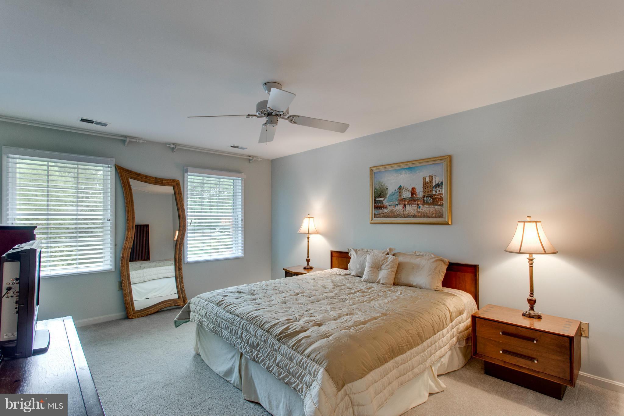 8230 Stacey Road Alexandria, VA 22308 - Photo 5 of 30 a bedroom with a bed and a lamp