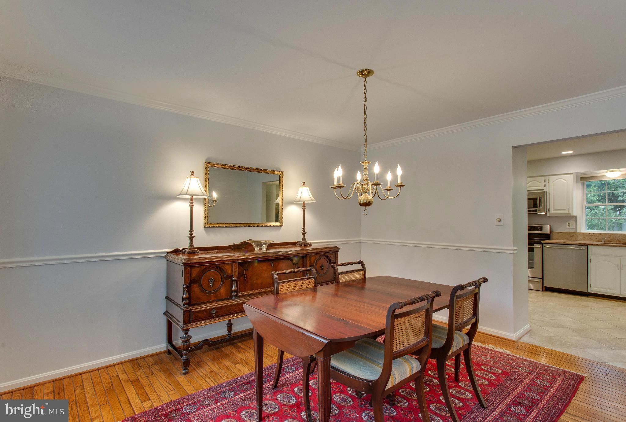 8230 Stacey Road Alexandria, VA 22308 - Photo 9 of 30 a view of a dining room with furniture and chandelier