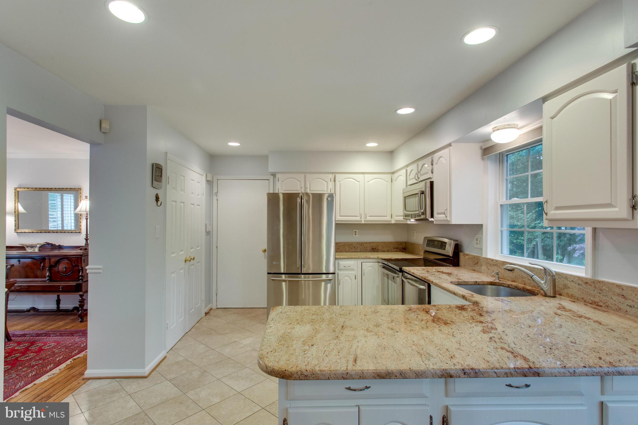 8230 Stacey Road Alexandria, VA 22308 - Photo 10 of 30 a kitchen with stainless steel appliances granite countertop a refrigerator and a sink