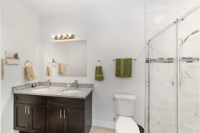 a bathroom with a sink toilet and mirror