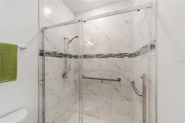 a bathroom with a shower and a glass door