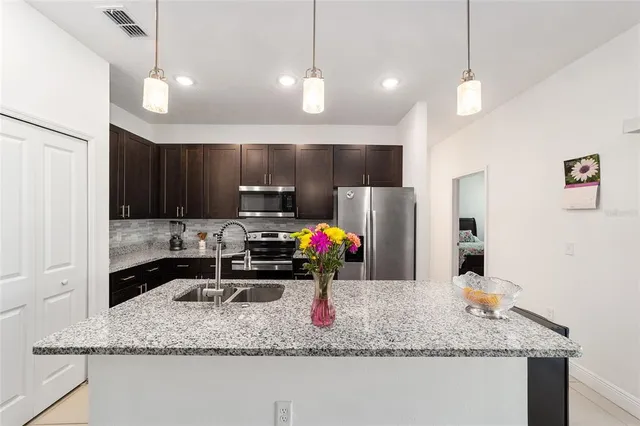 a kitchen with a refrigerator a sink and a wooden cabinets