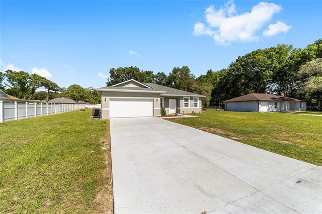 a view of house with outdoor space and swimming pool