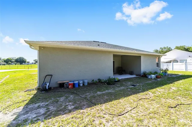 a view of a backyard with plants and a patio