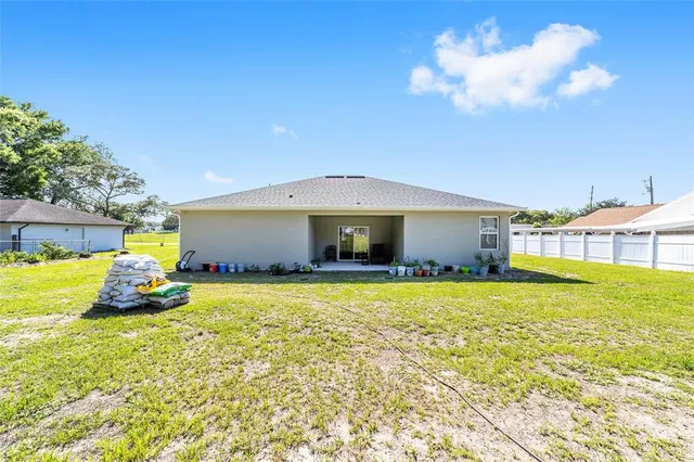 a view of a house with swimming pool and a yard