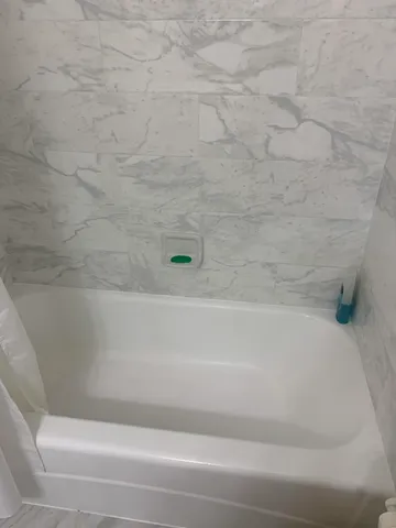 a living room with a bed and furniture