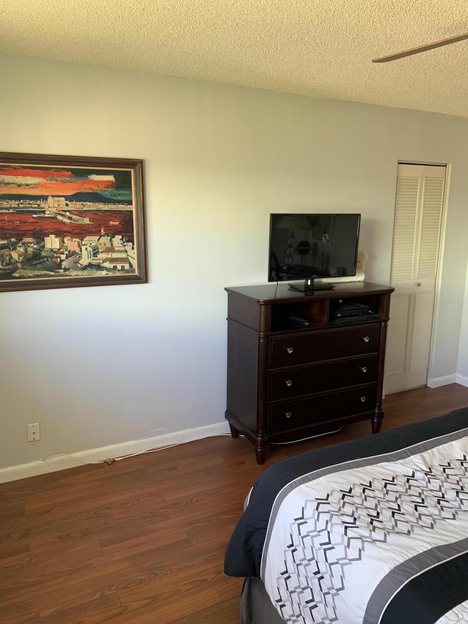 19 Colonial Club Drive, Unit 202 Boynton Beach, FL 33435 - Photo 13 of 18 a living room with a bed and furniture