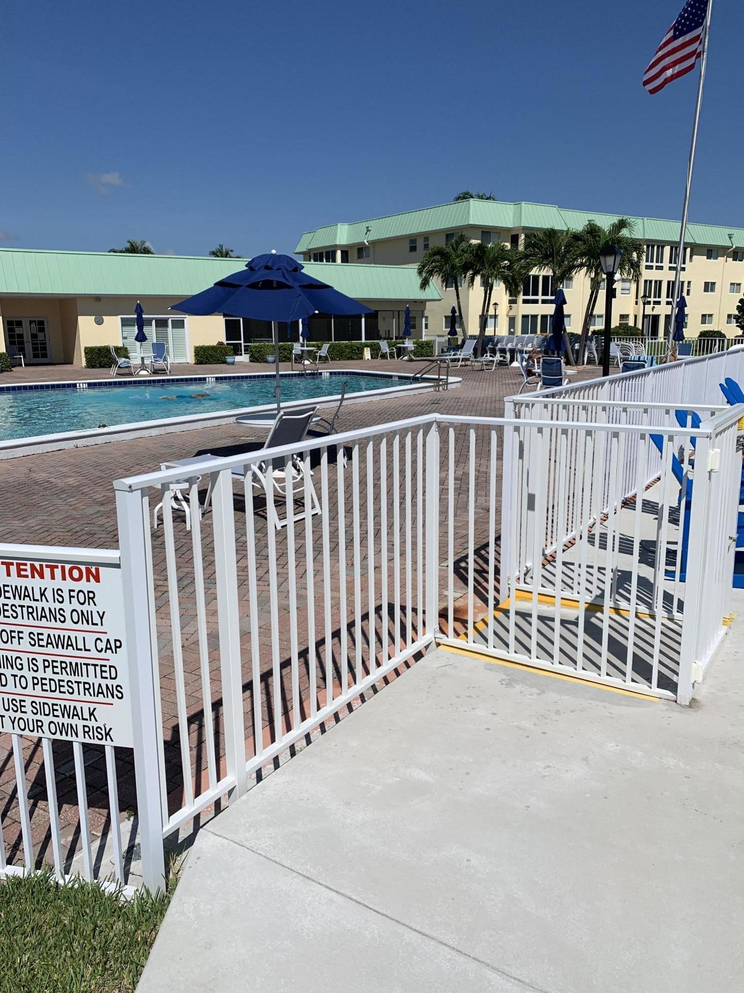 19 Colonial Club Drive, Unit 202 Boynton Beach, FL 33435 - Photo 16 of 18 a view of a patio with a table and chairs