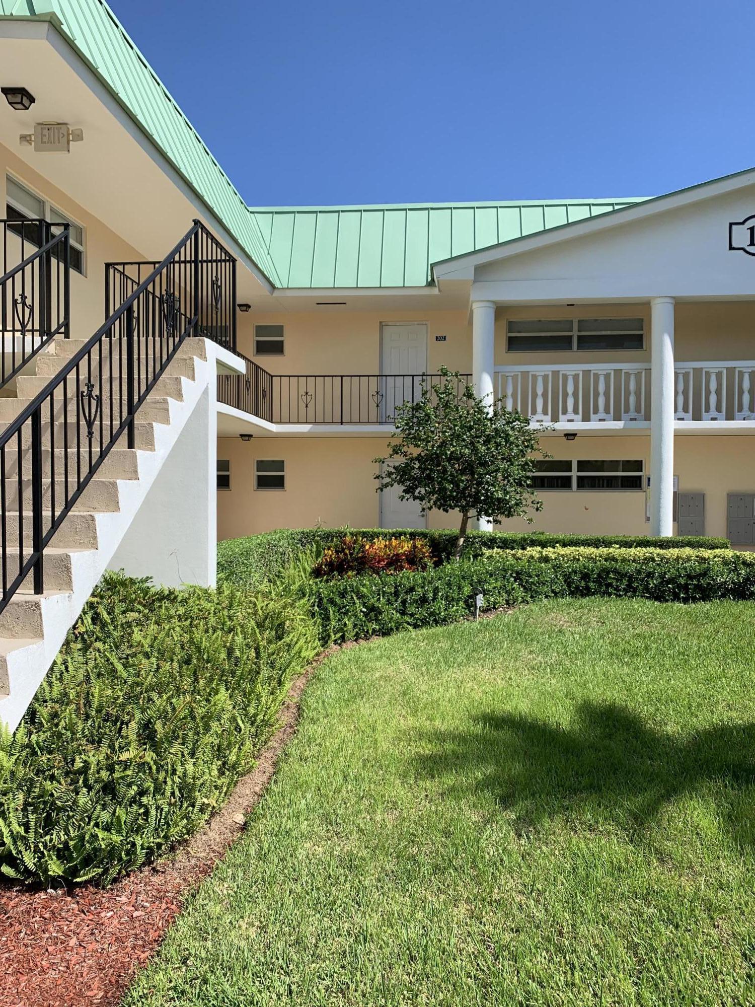 19 Colonial Club Drive, Unit 202 Boynton Beach, FL 33435 - Photo 4 of 18 a front view of a house with garden