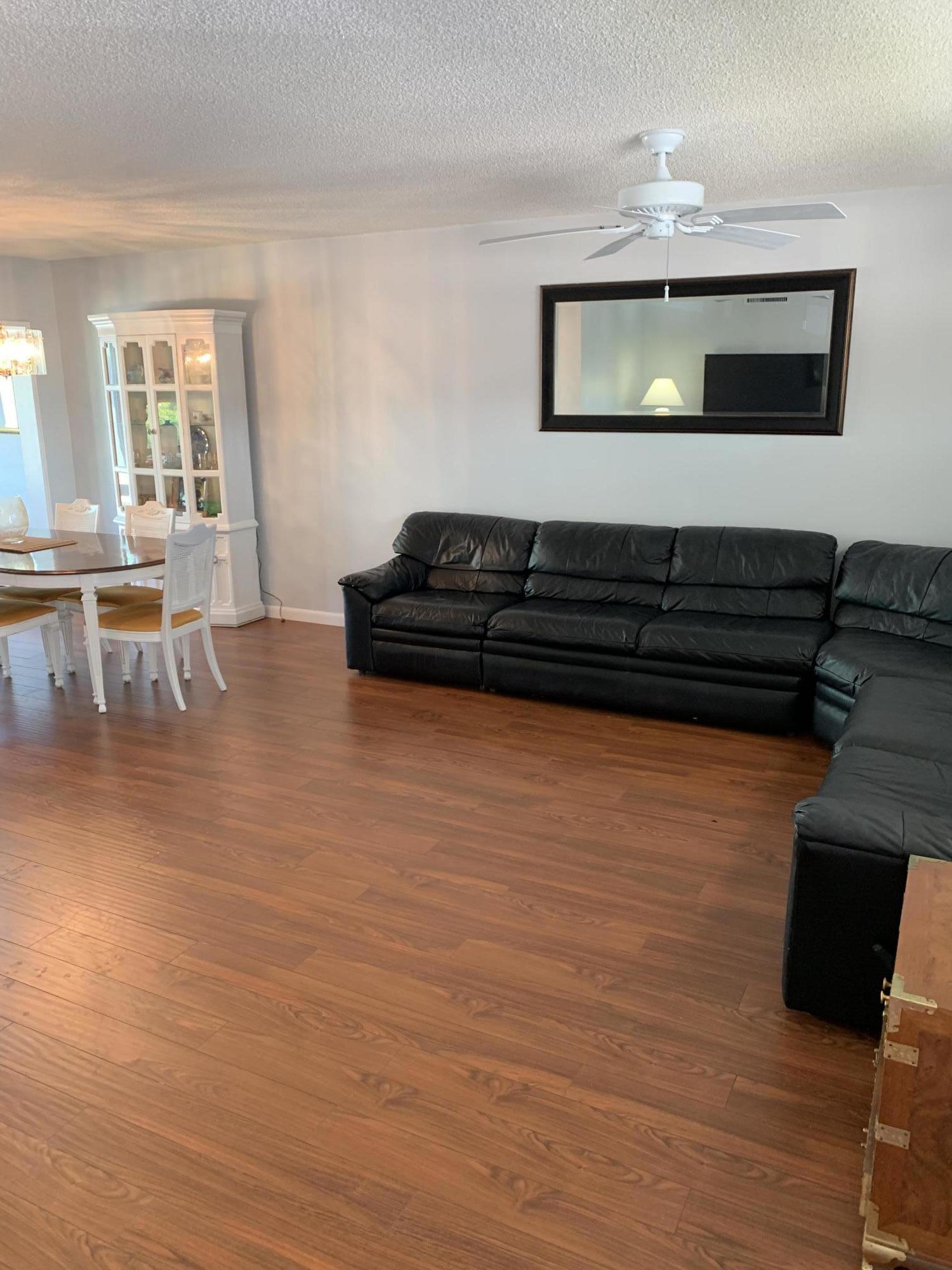 19 Colonial Club Drive, Unit 202 Boynton Beach, FL 33435 - Photo 6 of 18 a living room with furniture and a flat screen tv