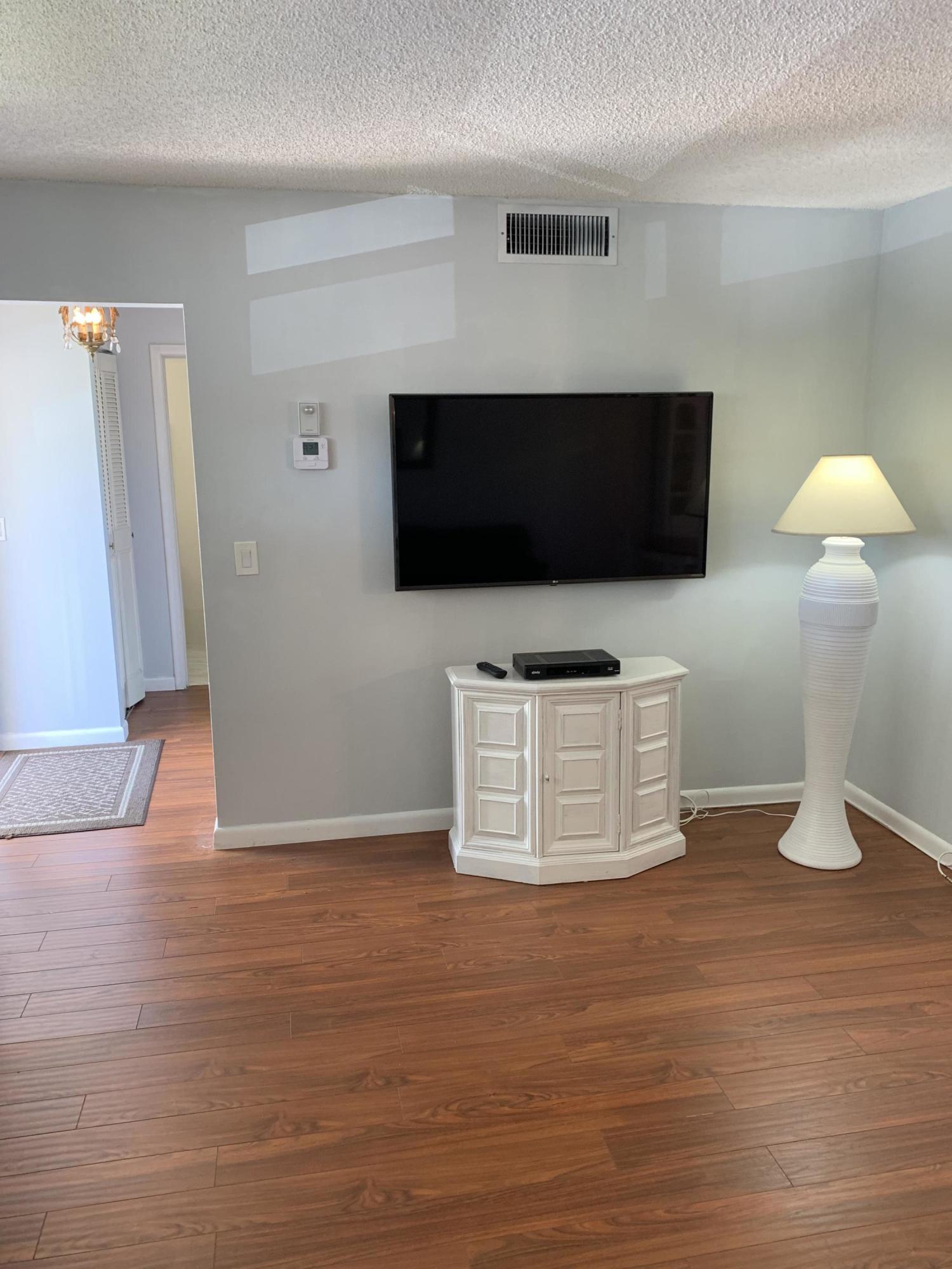 19 Colonial Club Drive, Unit 202 Boynton Beach, FL 33435 - Photo 7 of 18 a room with furniture and a flat screen tv