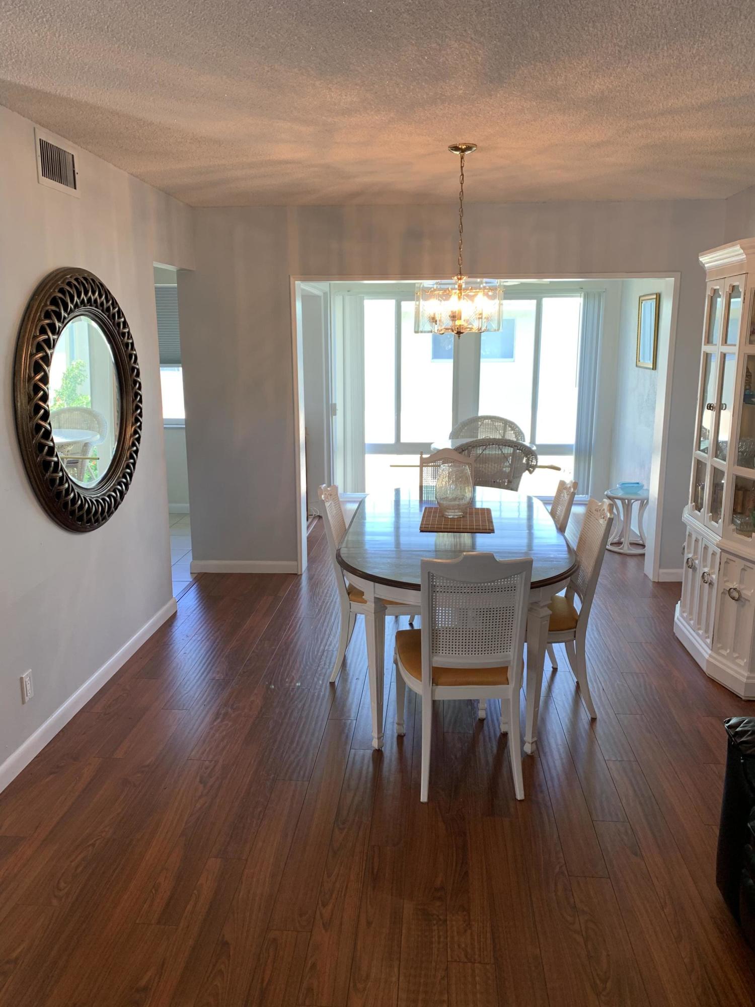 19 Colonial Club Drive, Unit 202 Boynton Beach, FL 33435 - Photo 8 of 18 a dining room with furniture window wooden floor
