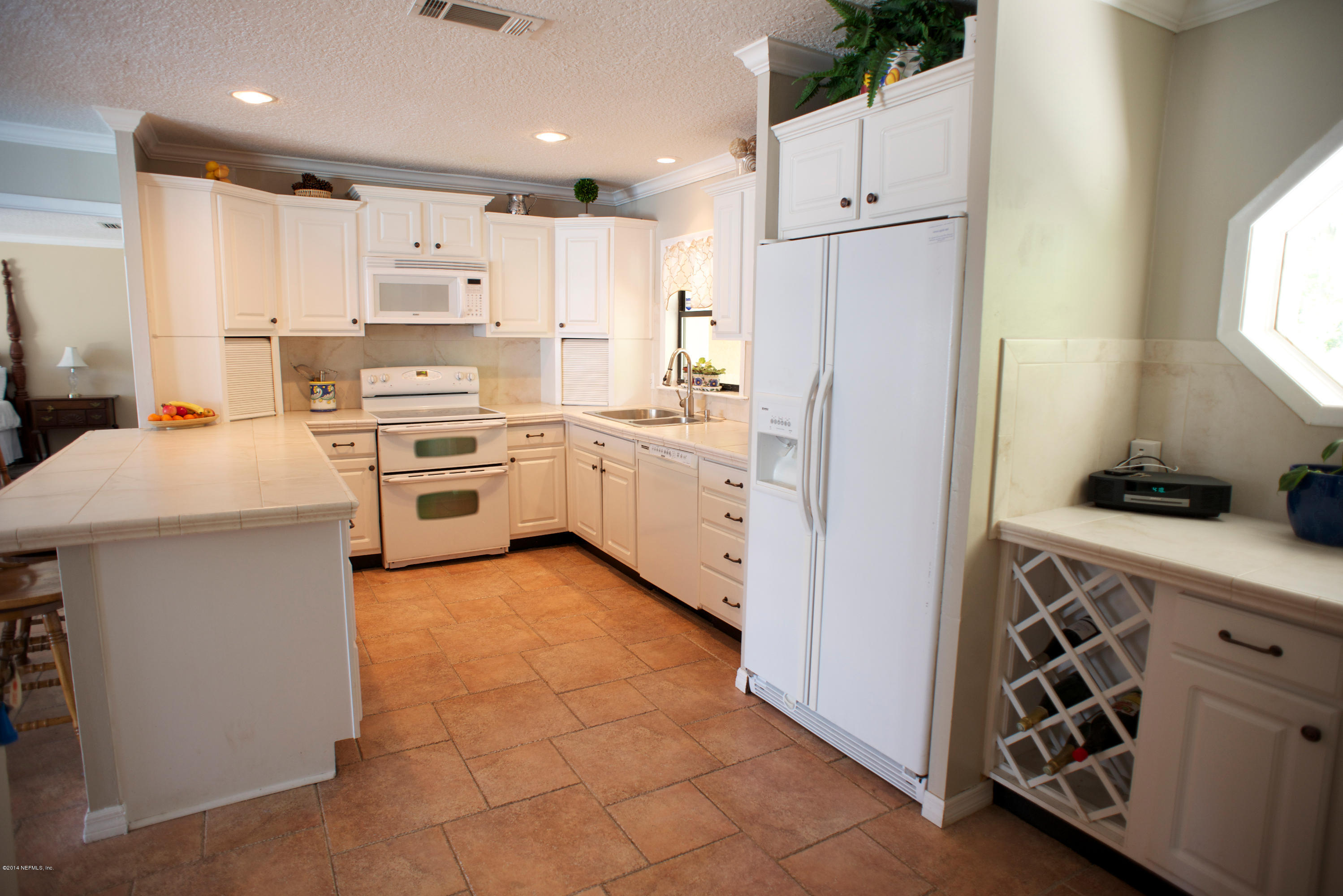 4109 Magnolia Road Orange Park, FL 32065 - Photo 8 of 32 a kitchen with white cabinets and white appliances