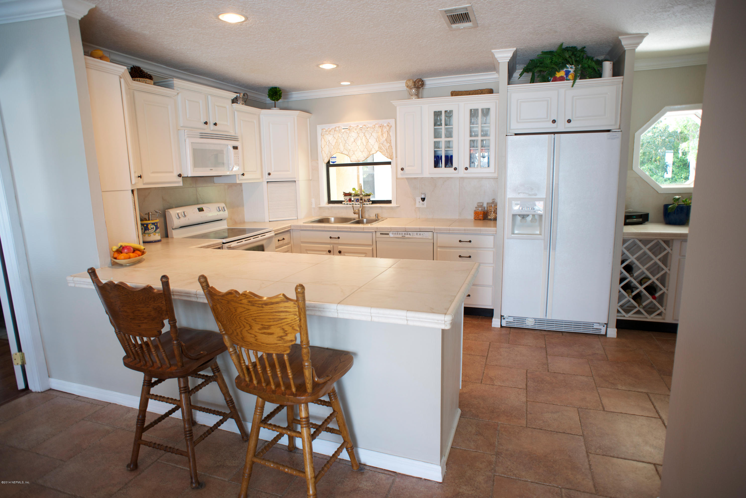 4109 Magnolia Road Orange Park, FL 32065 - Photo 9 of 32 a kitchen with refrigerator cabinets and table