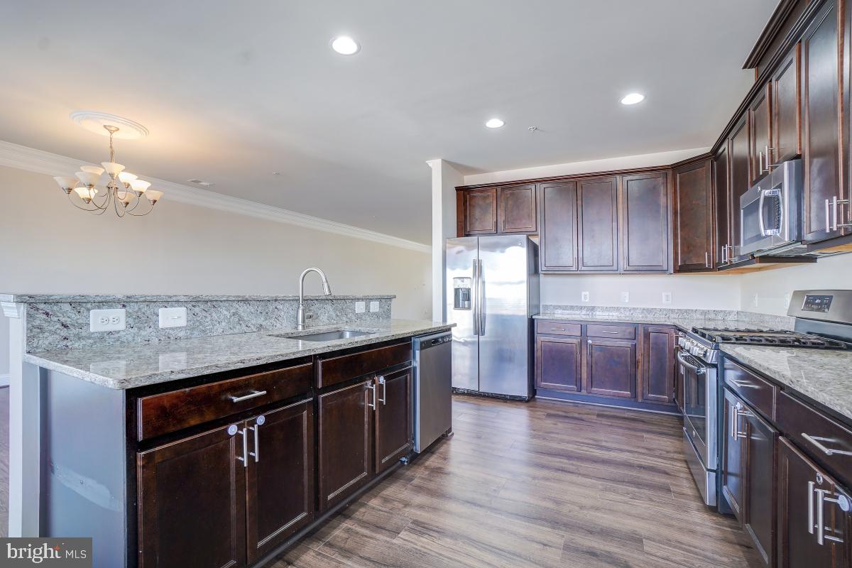 1709 Fieldstone Court Hanover, MD 21076 - Photo 15 of 30 a kitchen with stainless steel appliances granite countertop a sink stove and refrigerator