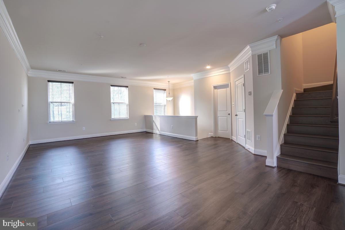 1709 Fieldstone Court Hanover, MD 21076 - Photo 4 of 30 an empty room with wooden floor and windows
