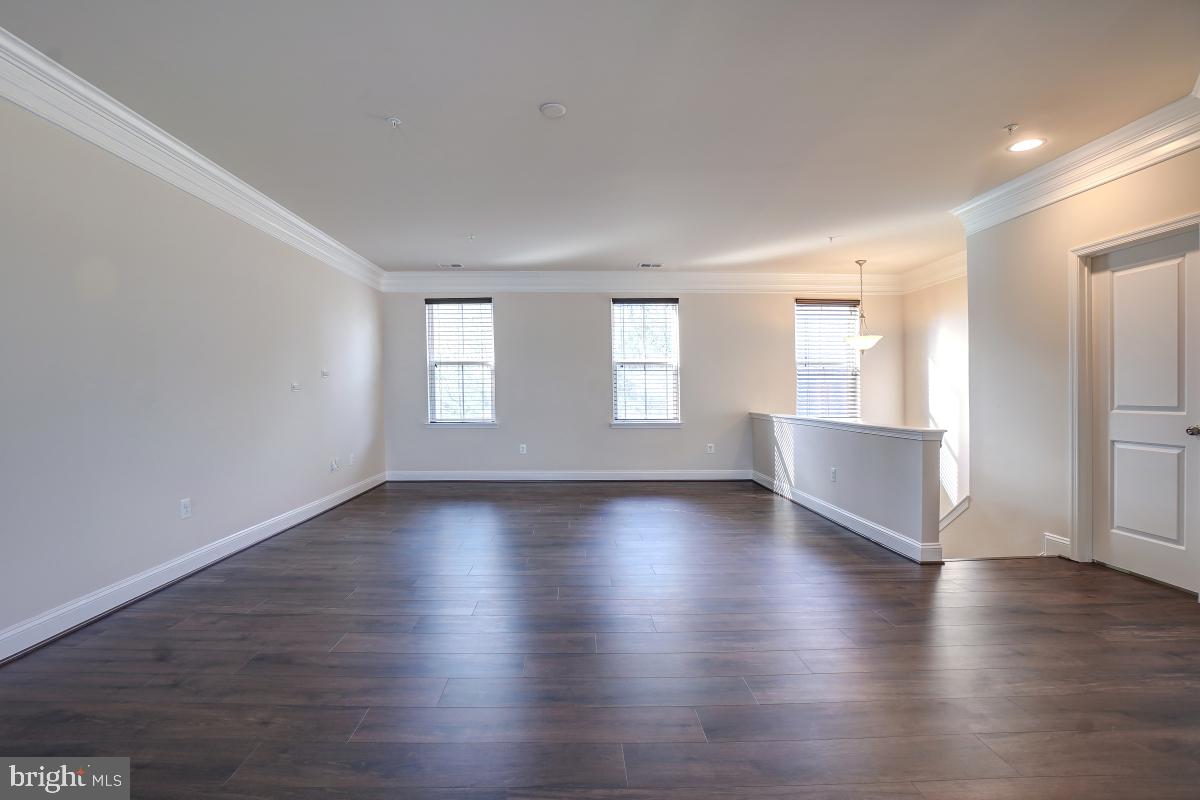 1709 Fieldstone Court Hanover, MD 21076 - Photo 5 of 30 an empty room with wooden floor and windows