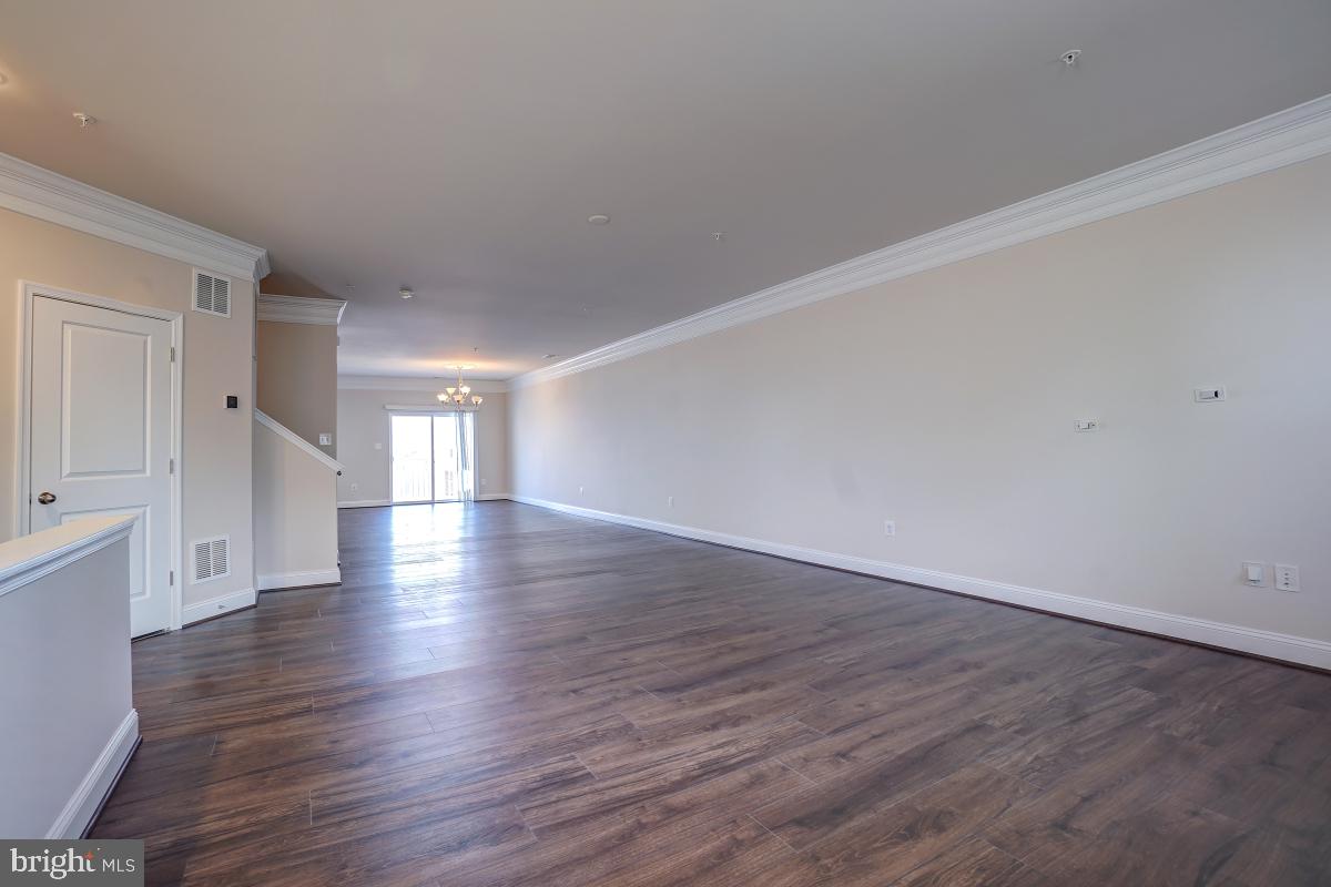 1709 Fieldstone Court Hanover, MD 21076 - Photo 6 of 30 a view of an empty room with wooden floor and windows