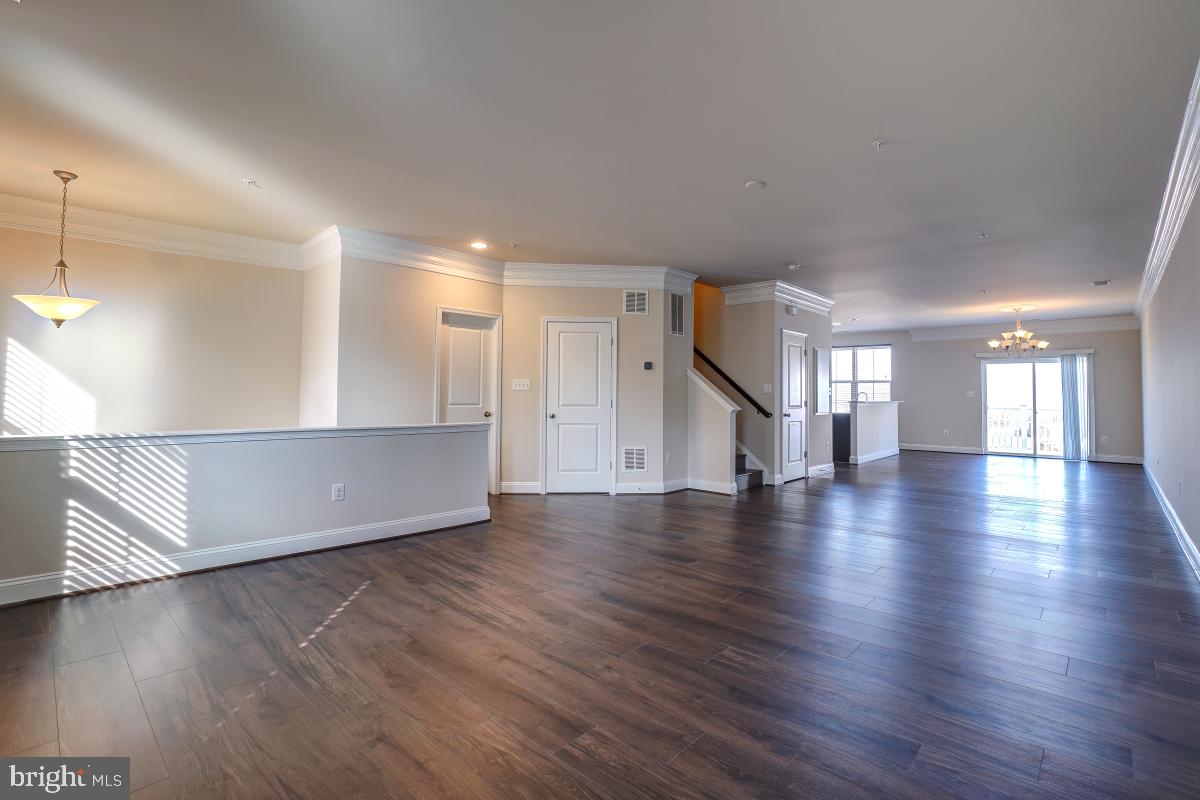 1709 Fieldstone Court Hanover, MD 21076 - Photo 7 of 30 a view of an empty room with wooden floor and a window