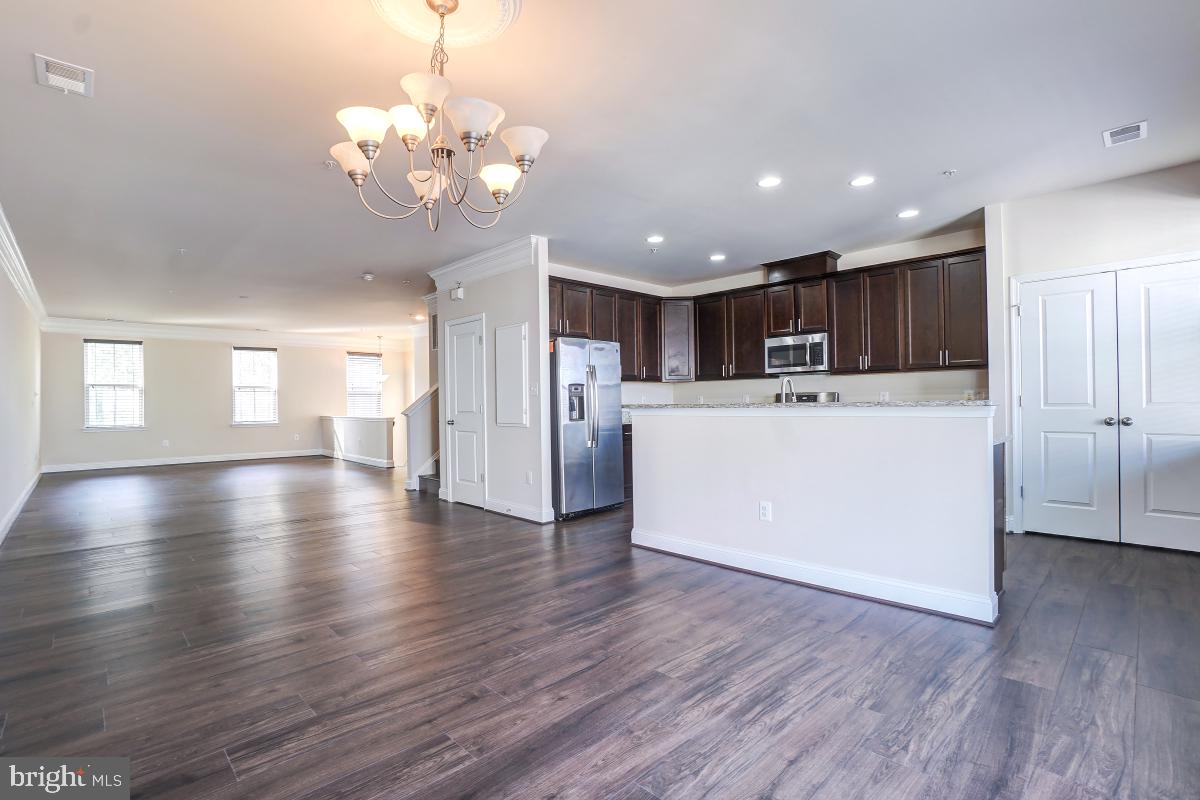 1709 Fieldstone Court Hanover, MD 21076 - Photo 10 of 30 a view of a big room with wooden floor and windows