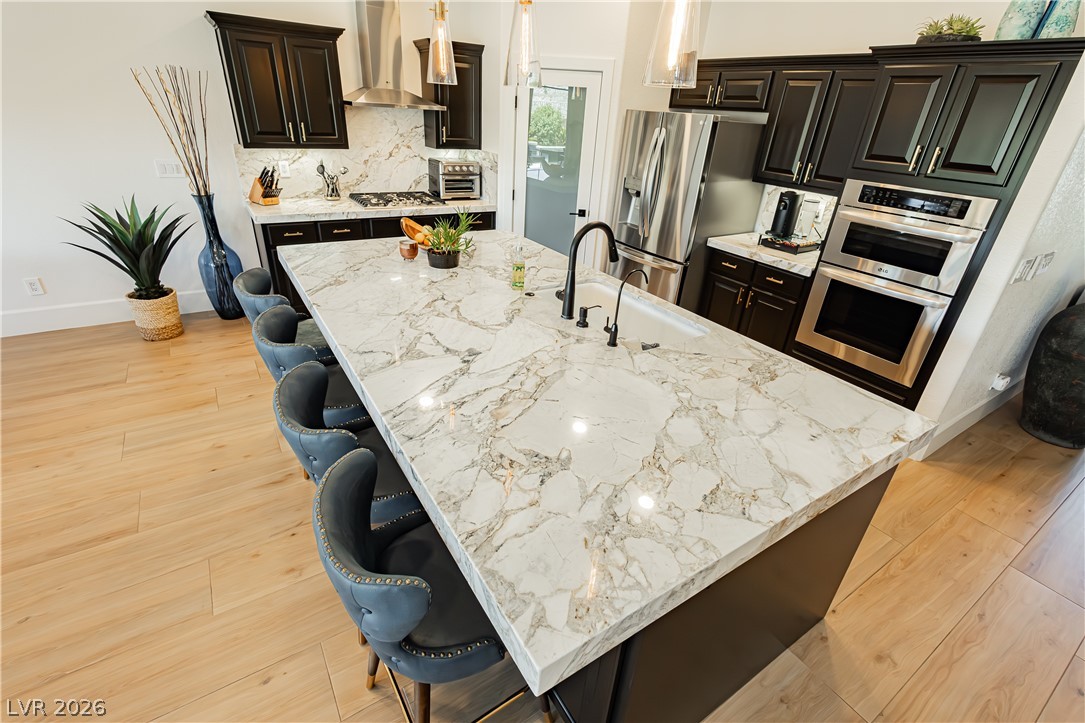 2256 Dogwood Ranch Avenue Henderson, NV 89052 - Photo 22 of 51 A well-appointed kitchen features a grand island with a sink and luxurious marble countertops.