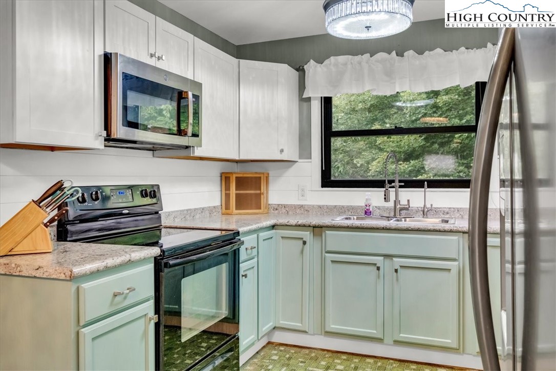 360 Fraser Road Sparta, NC 28675 - Photo 11 of 50 a kitchen with stainless steel appliances a stove sink and microwave