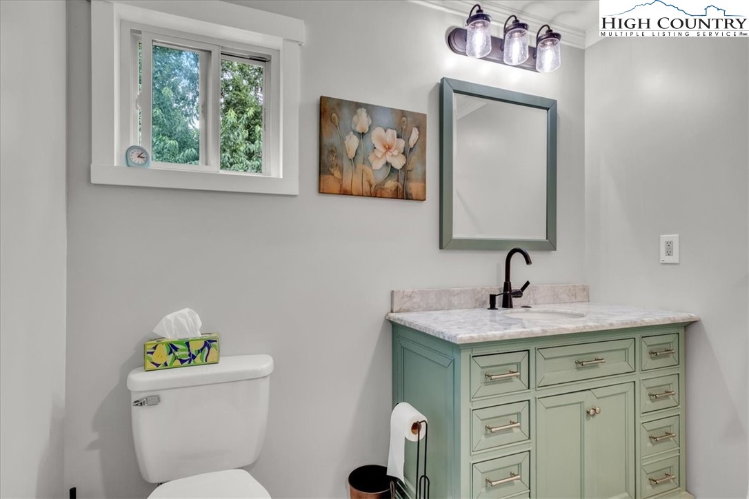 360 Fraser Road Sparta, NC 28675 - Photo 22 of 50 a bathroom with a toilet sink and mirror