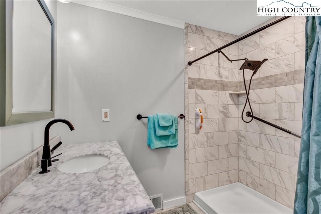 360 Fraser Road Sparta, NC 28675 - Photo 23 of 50 a bathroom with a sink and a mirror