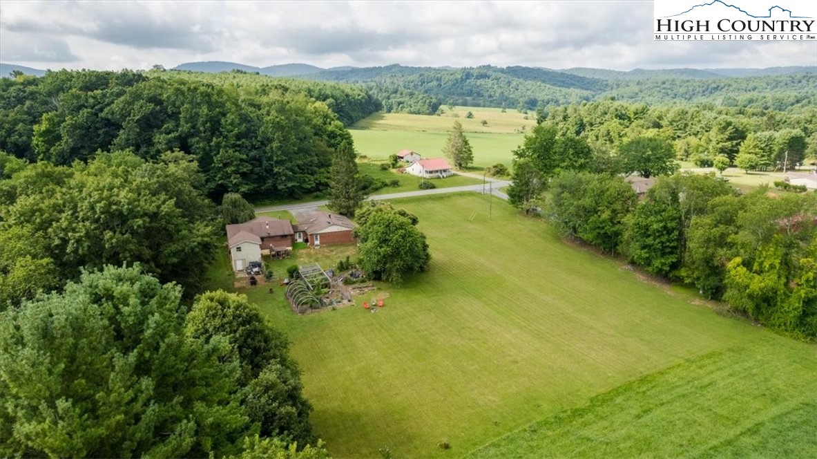 360 Fraser Road Sparta, NC 28675 - Photo 3 of 50 a view of a lake with houses in the back