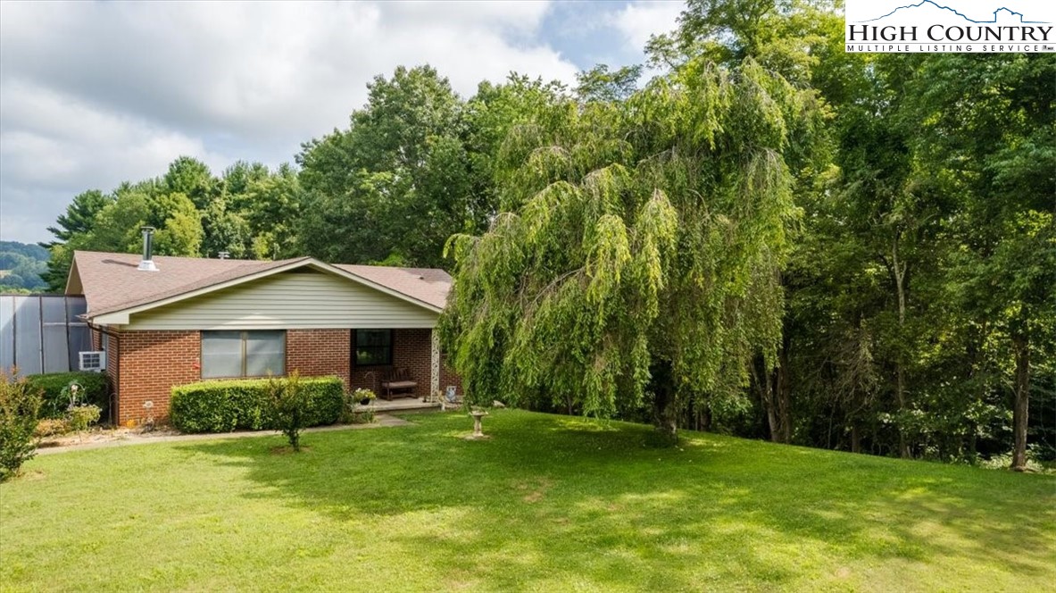 360 Fraser Road Sparta, NC 28675 - Photo 34 of 50 a front view of a house with a yard