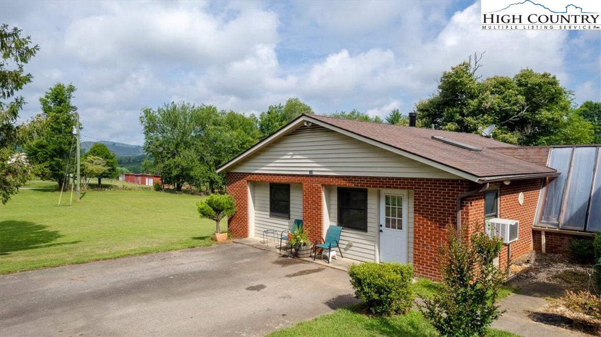 360 Fraser Road Sparta, NC 28675 - Photo 35 of 50 a view of a house with a yard potted plants and a table