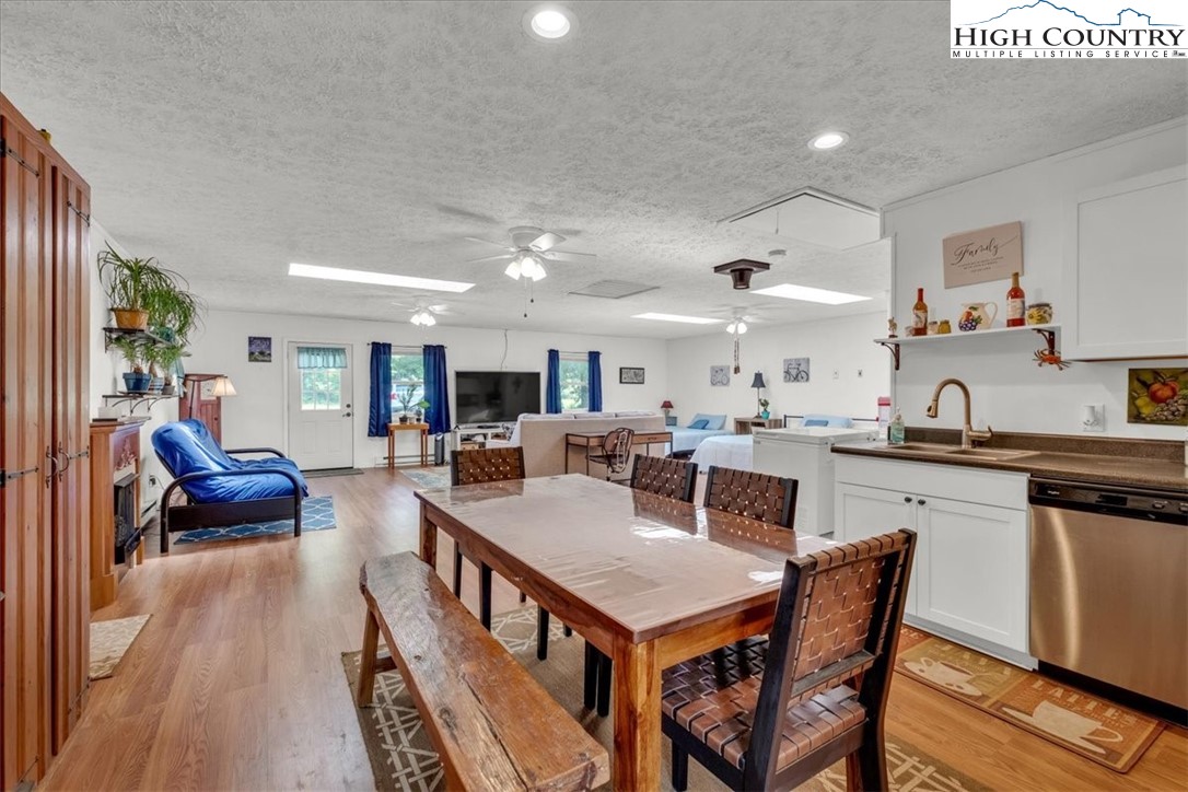 360 Fraser Road Sparta, NC 28675 - Photo 46 of 50 a kitchen with stainless steel appliances granite countertop a dining table chairs stove a sink and dishwasher